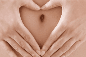 Heart hand over belly